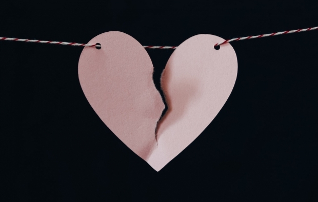 A paper heart with a tear in it