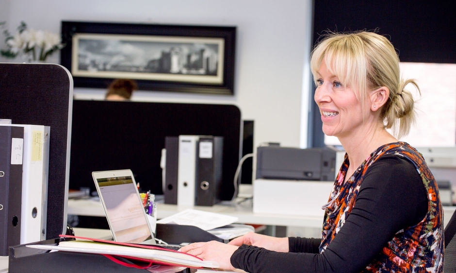 An image of a woman working in an office