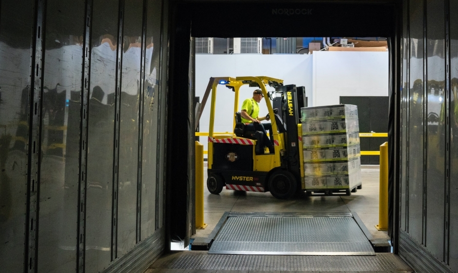 Man carrying boxes on a forklift truck