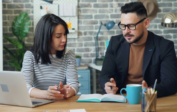 Two people discussing at a table